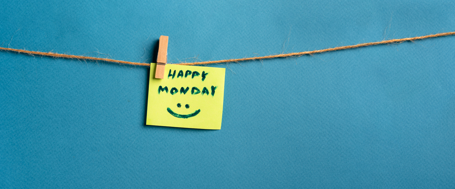 Motivational and inspirational quotes -"Happy monday". Text on hanging paper note.